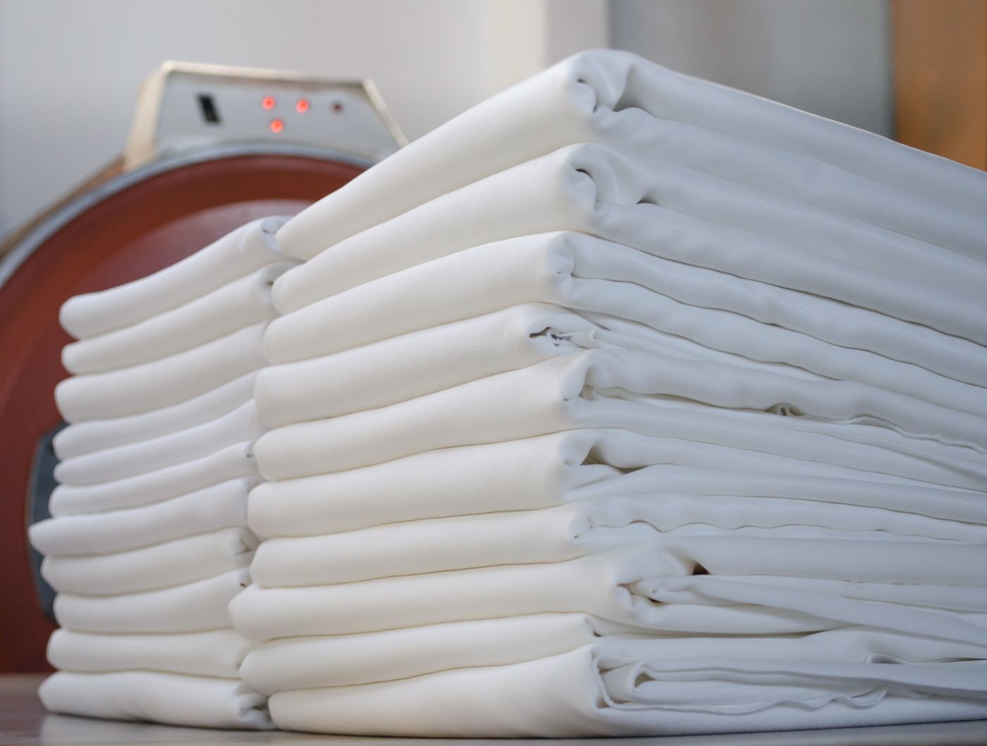 Tall stacks of freshly pressed and folded white linens