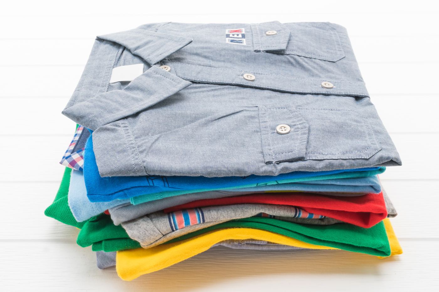Neat stack of clean folded shirts and t-shirts